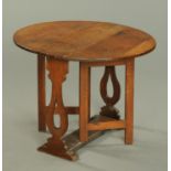 A Georgian oak drop leaf gate leg table. Width 78 cm.