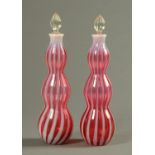 A pair of Edwardian triple gourd ruby and milk glass decanters, each with stopper. Height 36 cm.