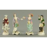 Four Continental porcelain figurines, each with floral encrusted bases. Height 19 cm.