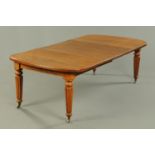 A Victorian oak extending dining table, with two leaves,