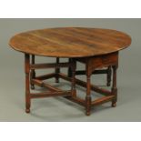 A George III oak gate legged dining table, oval,