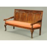 A George III oak four panelled settle, with silhouette arms,