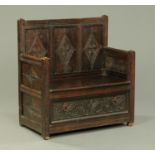 An oak three panelled settle, with solid seat and drawer to base. Width 93 cm.