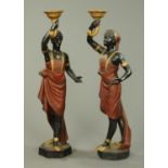 A pair of composition Blackamoor figures, black, gilt and red painted,