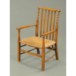 A rush seat fruitwood armchair.