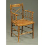 A 19th century simulated bamboo occasional chair, painted and with Bergere seat.