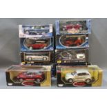 A group of 10 boxed large scale diecast model vehicles by makes including Maisto,