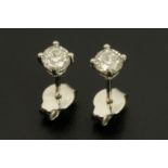A pair of 18 ct white gold diamond earrings, each set with a round brilliant diamond, weight +/- .