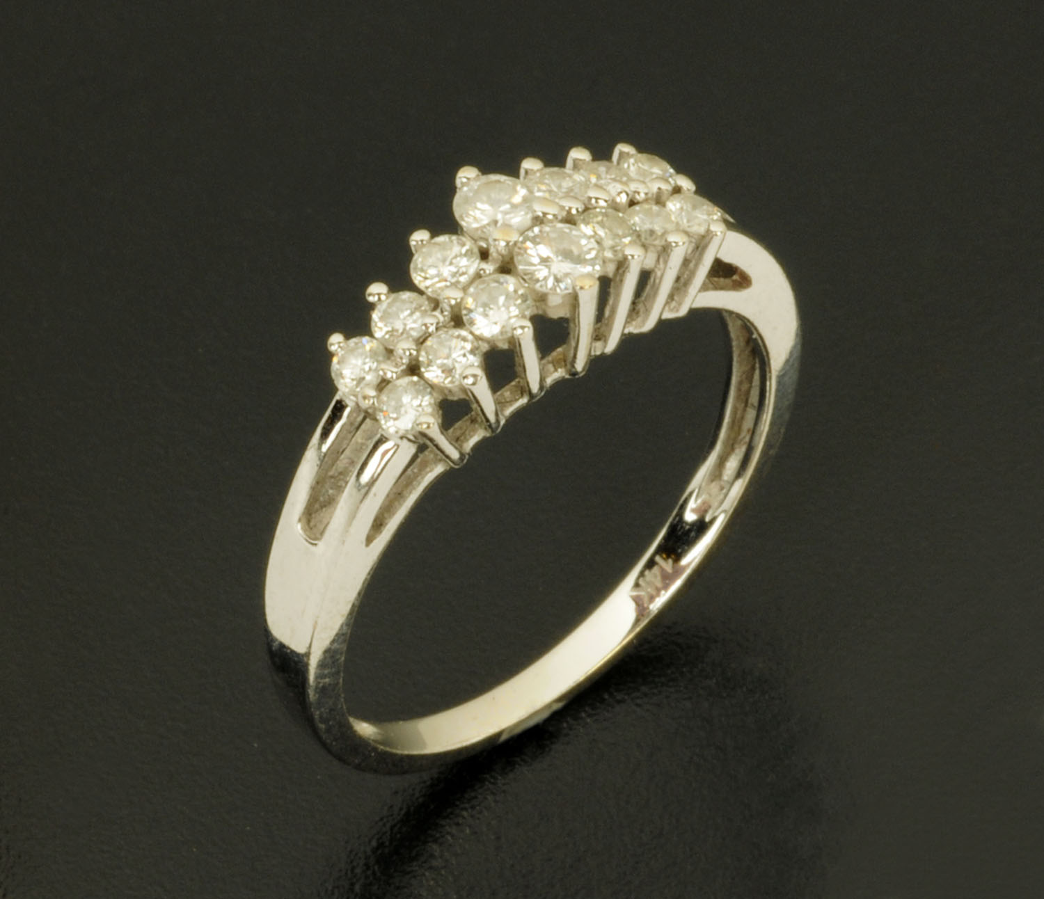 A 14 ct white gold fourteen stone diamond ring, stamped "14 k", size N/O.