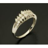 A 14 ct white gold fourteen stone diamond ring, stamped "14 k", size N/O.