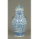 An 18th century Chinese blue and white lidded vase, with Buddhistic lion finial and mask handles.