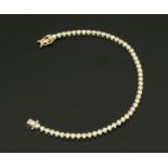 An 18 ct white gold tennis bracelet, set with diamonds weighing +/- 2.64 carats.