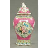 A Chinese lidded jar, figural, with pink ground and fo dog terminal to lid. Height 64 cm.