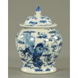 A 19th century Chinese blue and white lidded vase, decorated with lions. Height 18 cm.