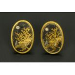 A pair of Japanese ear studs, with gold and silver coloured metal inlay. 18 cm x 11 cm.