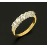 An 18 ct two tone gold five stone half eternity ring, set with diamonds weighing +/- 1.