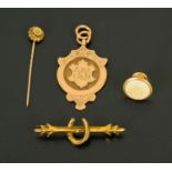 A 9 ct gold watch fob, 8.1 grams, and a stick pin, stud and 9 ct gold horseshoe stick pin.