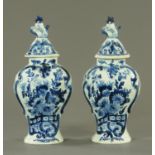 A pair of early 20th century Dutch Delft lidded vases. Height 36 cm.