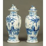 A pair of 19th century Chinese blue and white lidded vases, decorated with figures and insects,