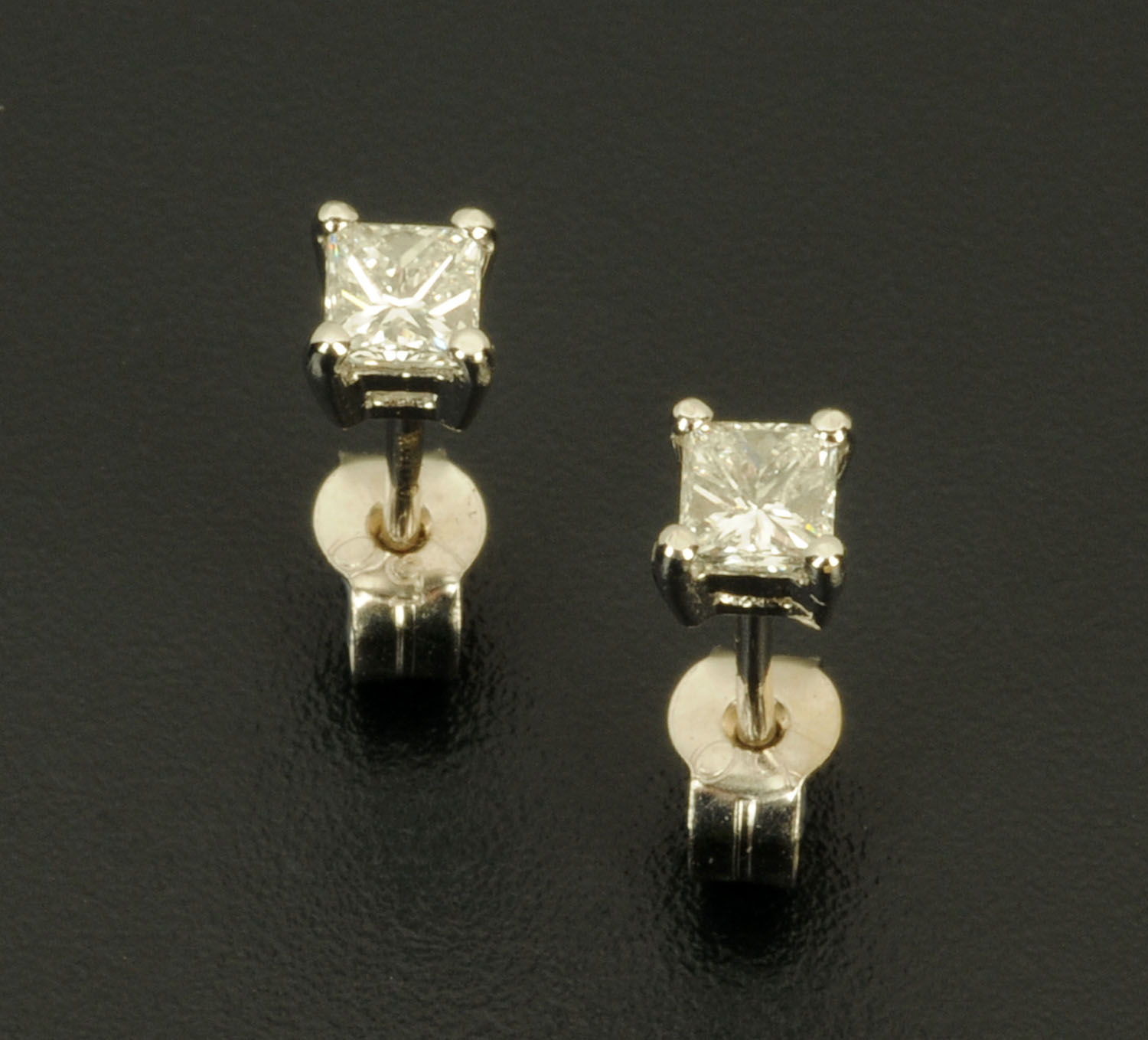 A pair of 18 ct white gold stud earrings, set with princess cut diamonds weighing +/- .50 carats.