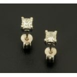 A pair of 18 ct white gold stud earrings, set with princess cut diamonds weighing +/- .50 carats.
