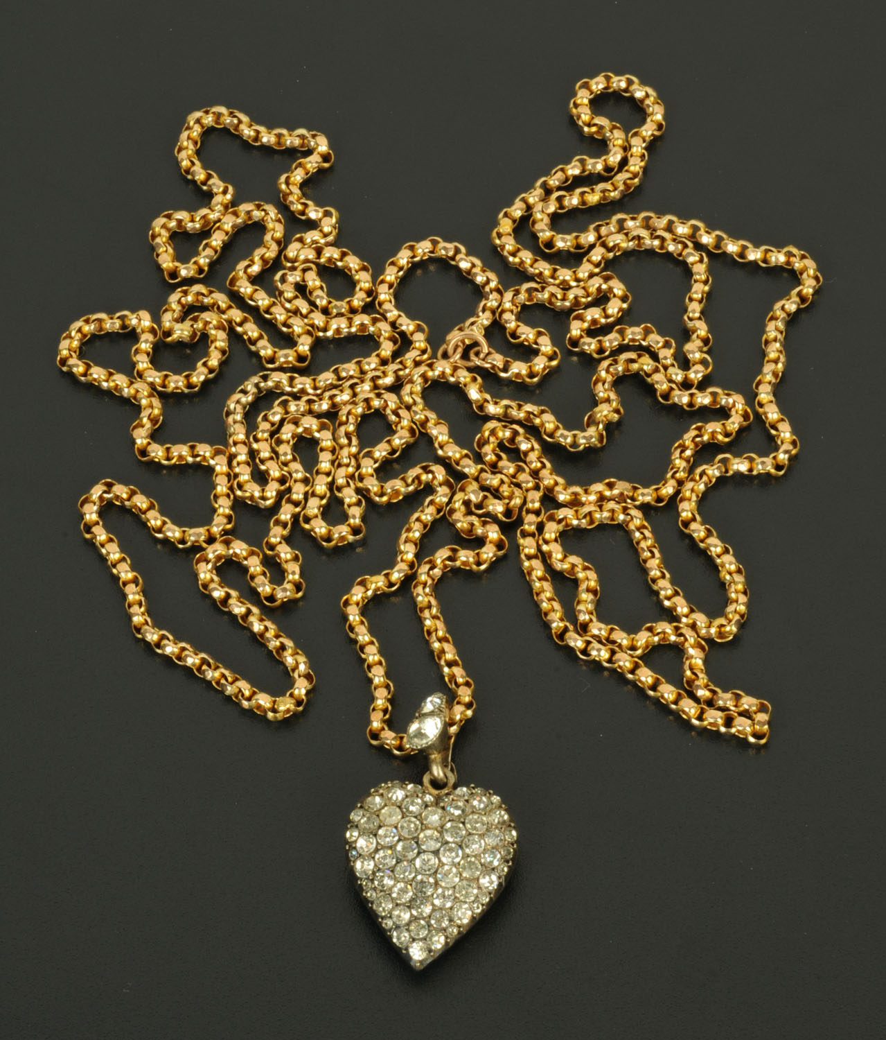 A 9 ct gold guard chain, with paste set heart shaped locket, chain weight only 23.