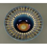 A Tobias Harrison blue and gilt ceramic bowl. Diameter 24.5 cm.