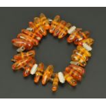 An Art Deco period chrome and amber bead elasticated bead bracelet, circa 1930 (AF).