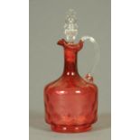 A Victorian cranberry glass dimpled decanter with stopper.