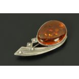 A 1960's comet design silver and amber brooch, inclusions.