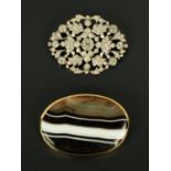 A 9 ct gold mounted banded agate brooch/pendant, 50 mm x 38 cm, and a paste brooch.