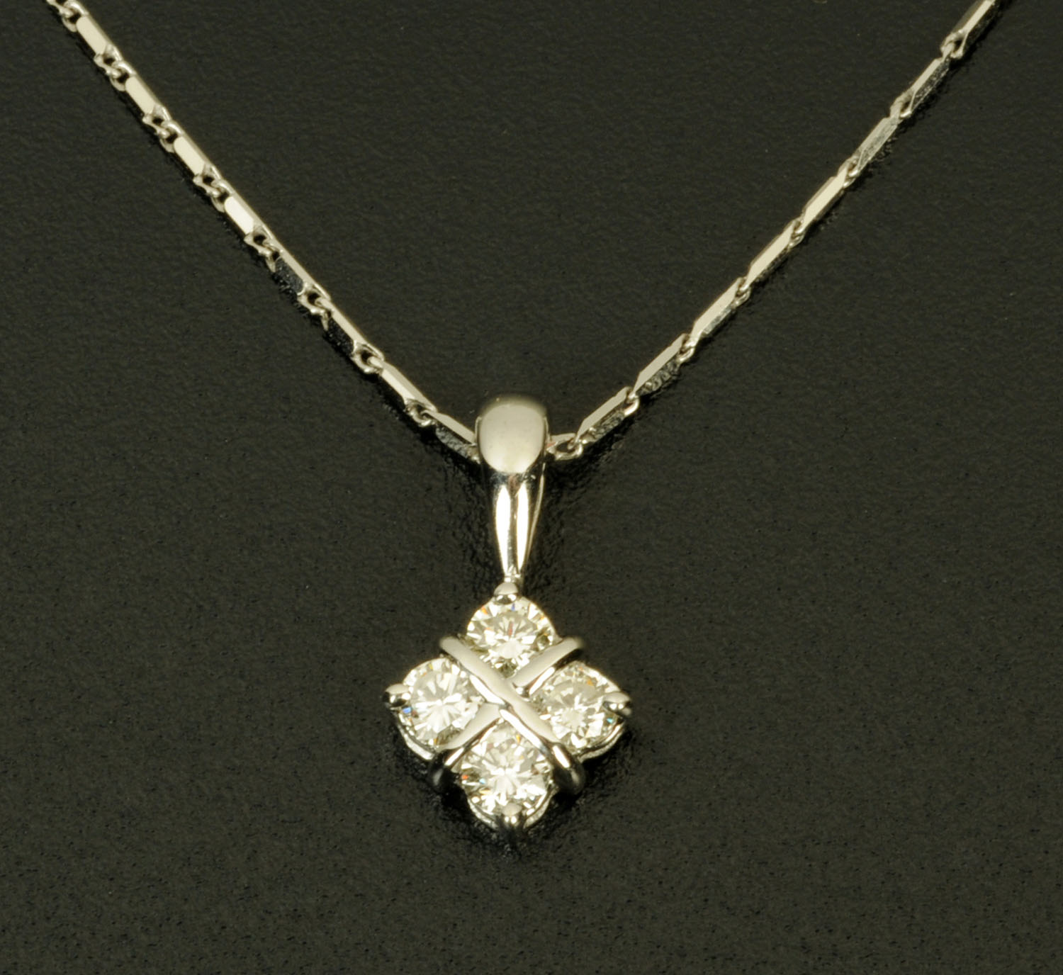 An 18 ct white gold pendant on chain, set with diamonds weighing +/- .34 carats.