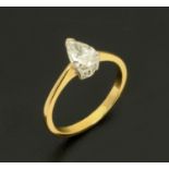 An 18 ct two tone gold solitaire diamond ring, pear shaped, weighing +/- .72 carats, size L/M.