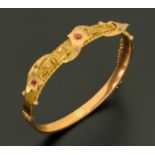 A 9 ct gold bangle, set with small diamonds and red stones, 8.4 grams gross.