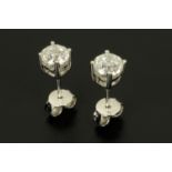 A pair of 18 ct white gold round brilliant cut stud diamond earrings, diamond weight +/- 1.