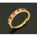 An 18 ct yellow gold half eternity ring, set with alternating diamonds and rubies weighing +/- .