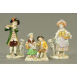 A pair of Sitzendorf figures, musician and girl with flowers, and another. Tallest 18 cm.