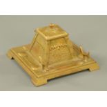 An Art Nouveau brass inkwell, circa 1900, with embossed pendant drops above a stippled ground,