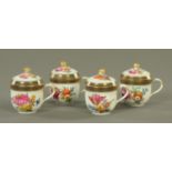 Four Meissen chocolate cups and covers, decorated with floral sprays, crossed swords mark to base.