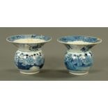 A pair of Chinese blue and white spittoons, late 19th century, painted with chrysanthemums,