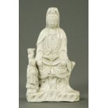 A Blanc de Chine figure of Guanyin, 19th century, in seated pose with attendant. Height 22.