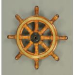 A brass bound and teak ships wheel, with eight spokes. Diameter 70 cm (see illustration).