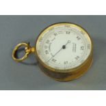 A lacquered brass pocket barometer, late 19th century, the silvered dial signed "J Lucking & Co.