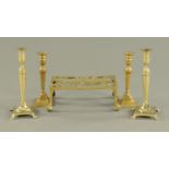 A pair of brass candlesticks, 19th century, with tapering stem on square foot with paw feet,