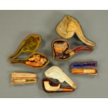 A gold mounted carved Meerschaum pipe, two others and two cheroot holders.