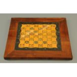 A Victorian chessboard, painted with heraldic crests and in rosewood frame. 55 cm square.