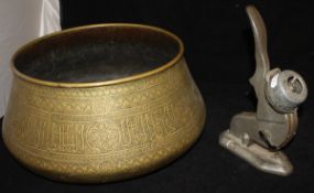 An Indian brass deep bowl with script and scrolling foliate decoration,