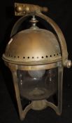 An early 20th Century patinated brass ship's lamp on gimble mount,