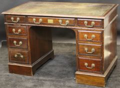 A Victorian mahogany pedestal desk in the Adam taste by Howard & Sons with green leather tooled