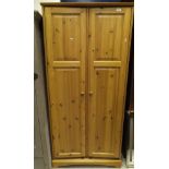 A suite of pine bedroom furniture to include a two door wardrobe, double bed frame,